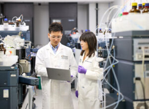 Chihiro Sato, PhD, and Kanta Horie, PhD, work in the mass spectrometer lab in the BJC Institute of Health