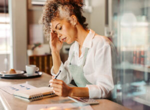 Woman sitting at desk with pen and paper